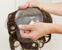 the adhesive hair piece gets prepared by the specialist studio